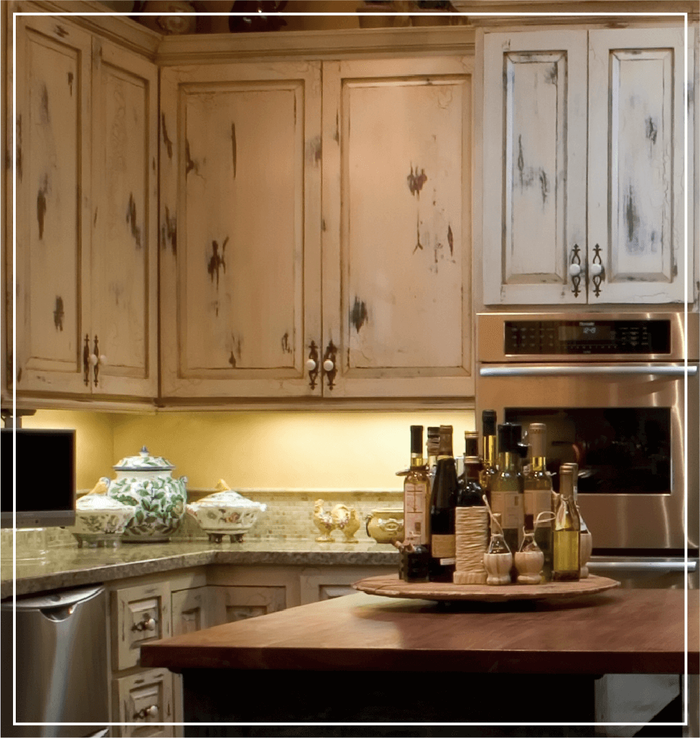 Subtle white kitchen cabinets with a distressed finish.