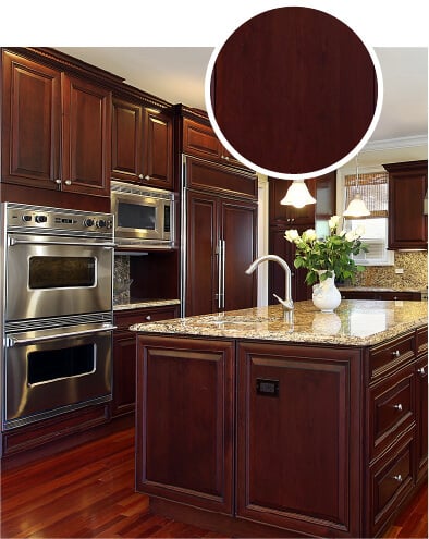 Traditional dark cherry wood kitchen with granite countertops.