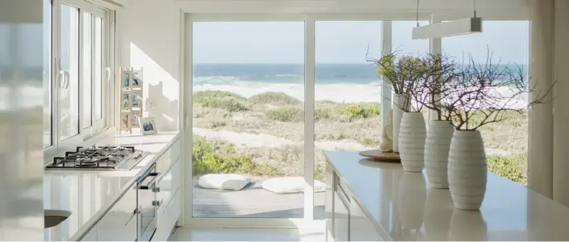 Light coastal kitchen with ocean view.