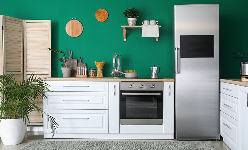 Kitchen uses accents of a bold green to be colorful without overwhelming.