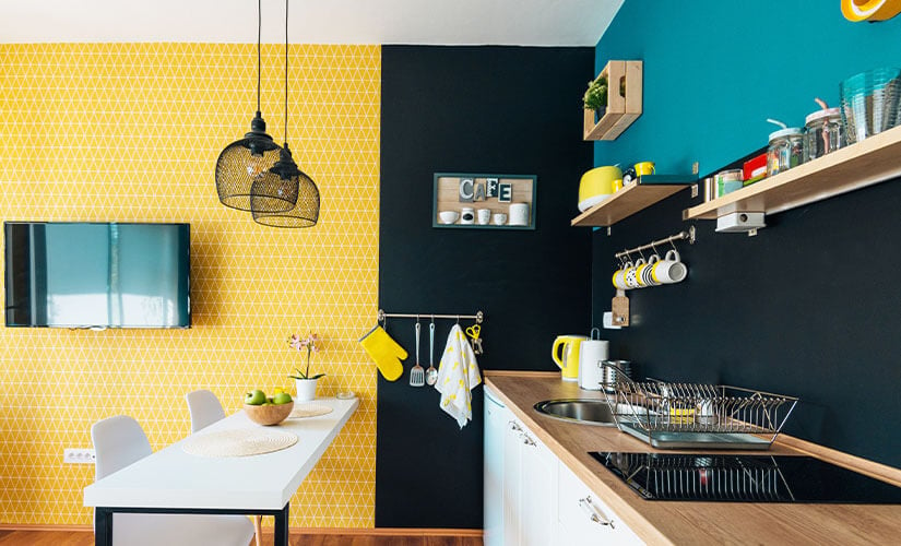 Kitchen with a colorful accent wall using wallpaper.