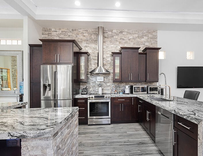 Modern kitchen with marble countertops and a blind corner cabinet.