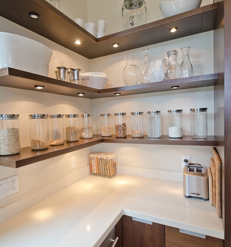 Dark open corner shelving with clear containers on shelves.