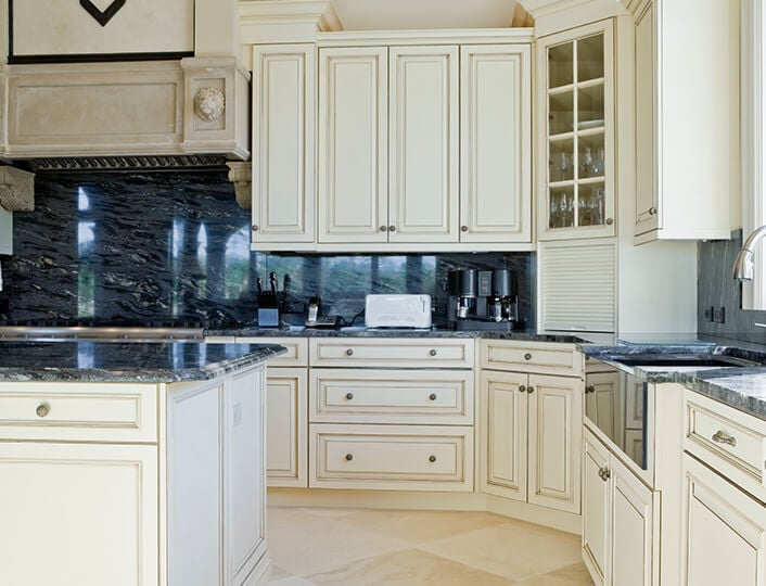 Traditional kitchen with diagonal corner glass cabinet and a garage cabinet door.