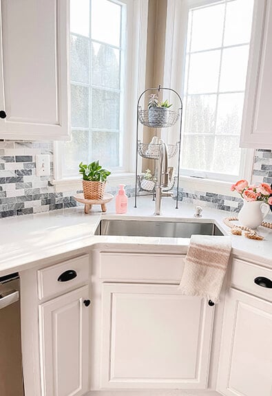 Stainless steel corner kitchen sink with two windows.