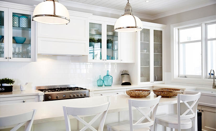 White kitchen with glass upper cabinets.