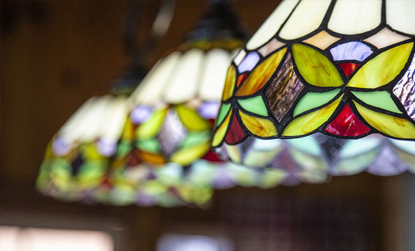 Close up of stained glass pendant lights.