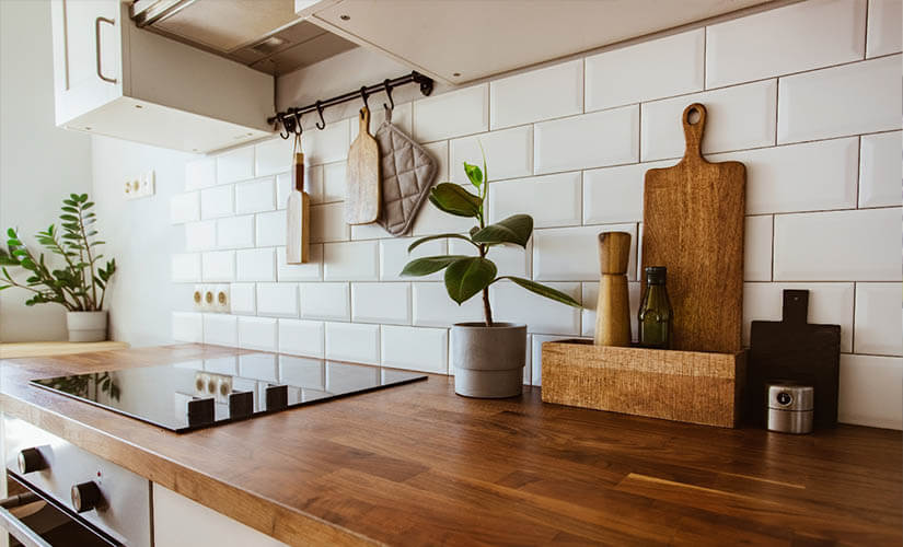 kitchen with wood countertops and subway tile backsplash.