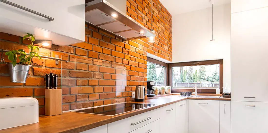 Exposed brick in a modern farmhouse kitchen.