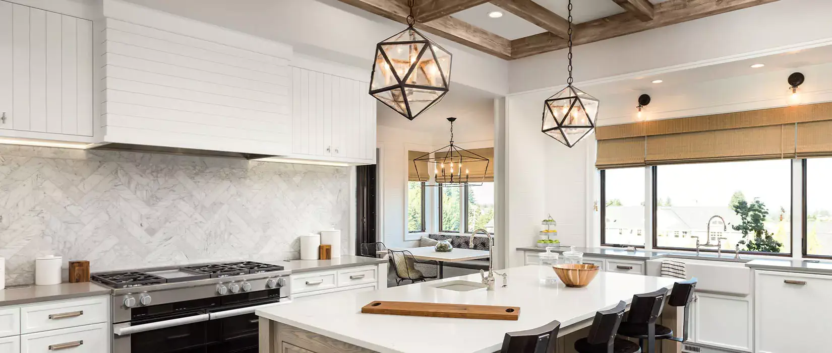 Modern farmhouse kitchen with pendant lights, wood beams, and natural wood elements.