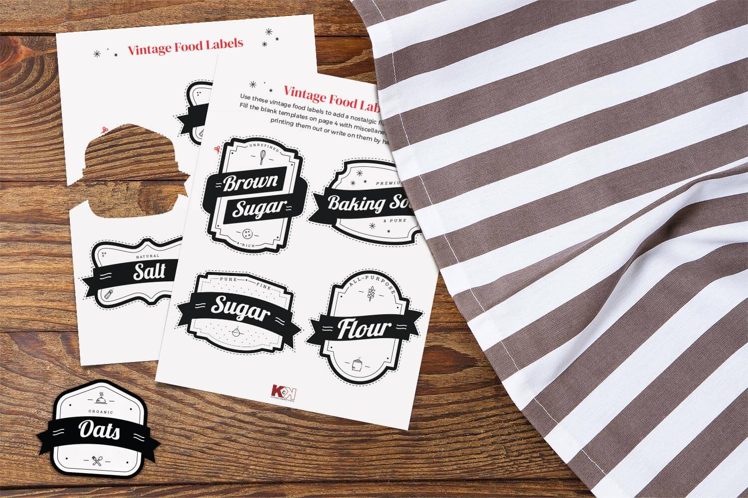 Vintage food label templates on dark wood surface with striped white and brown tablecloth.