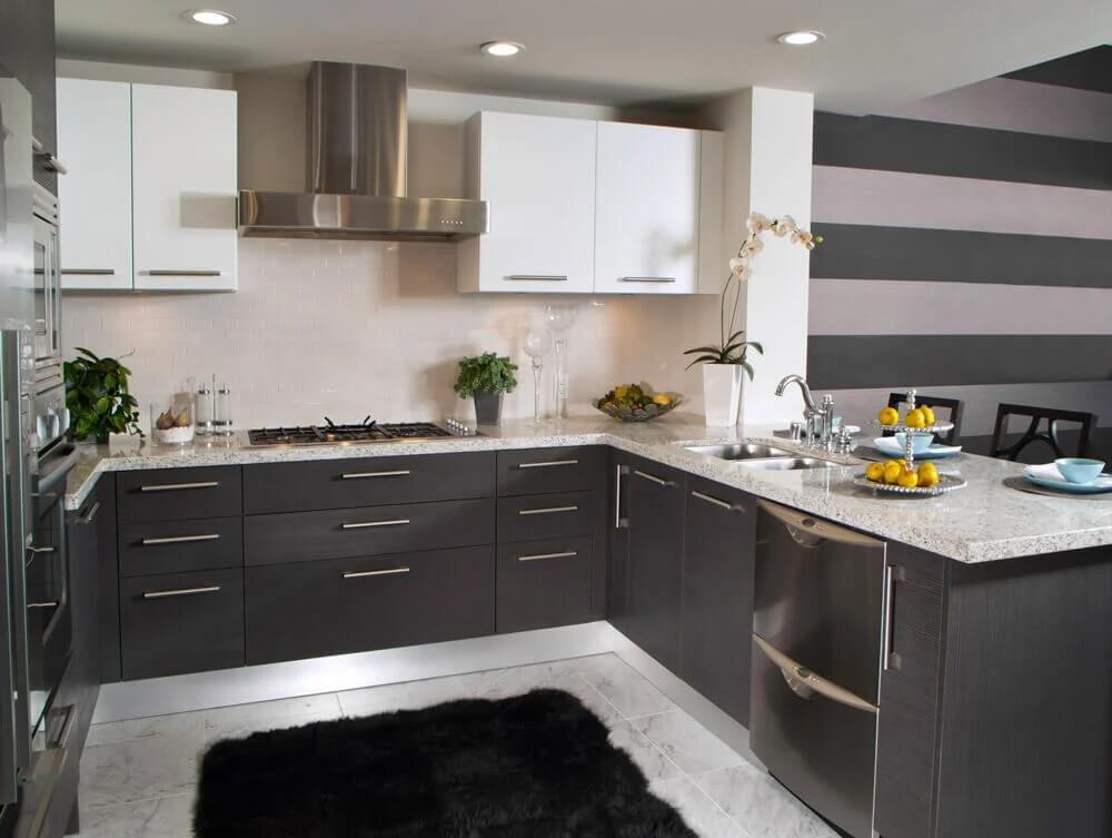 A g-shaped kitchen with dark cabinetry.