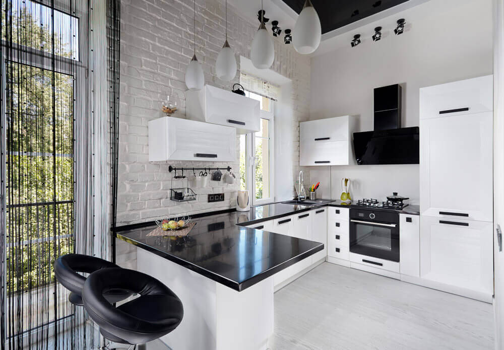 A g-shaped kitchen with all white cabinetry.