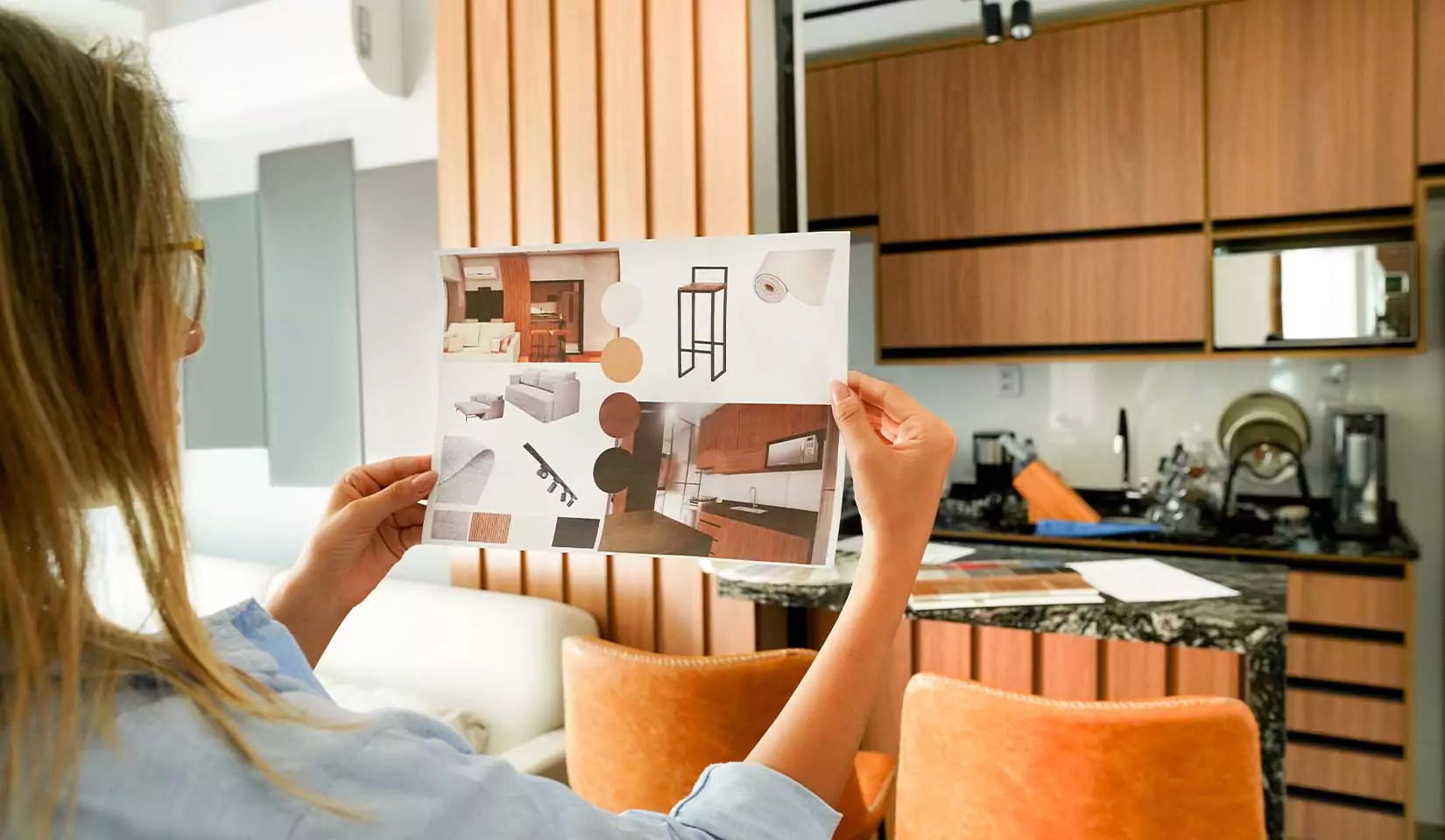 A person looking at the mock up of kitchen layout.
