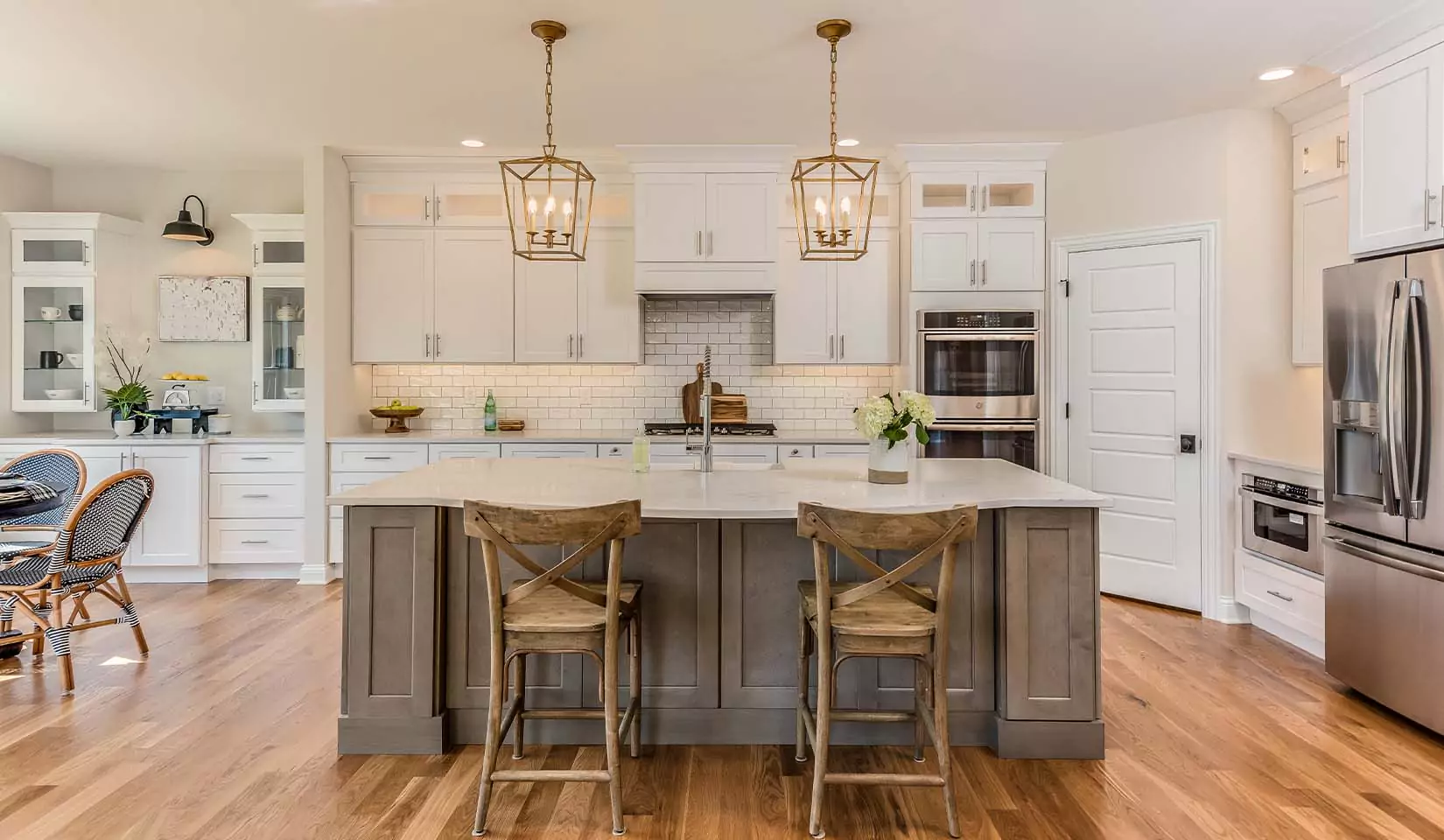 Statement, modern lighting above a kitchen table in an open-concept kitchen.