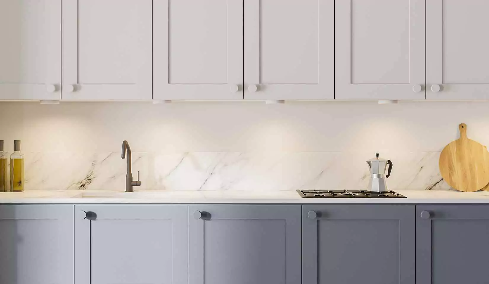 Two-toned cabinets in a kitchen, with white upper cabinets and slate gray lower cabinets.