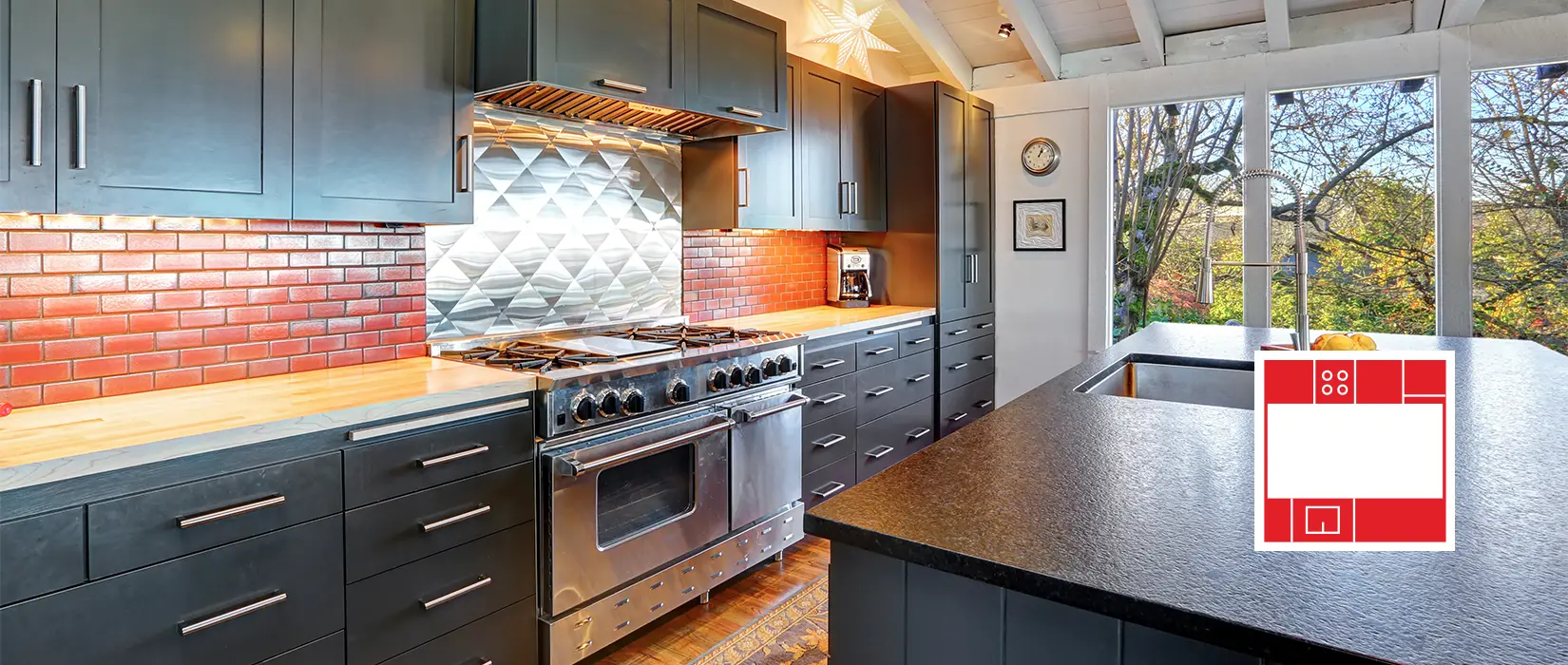Galley kitchen layout with dark blue cabinets and marble countertops.