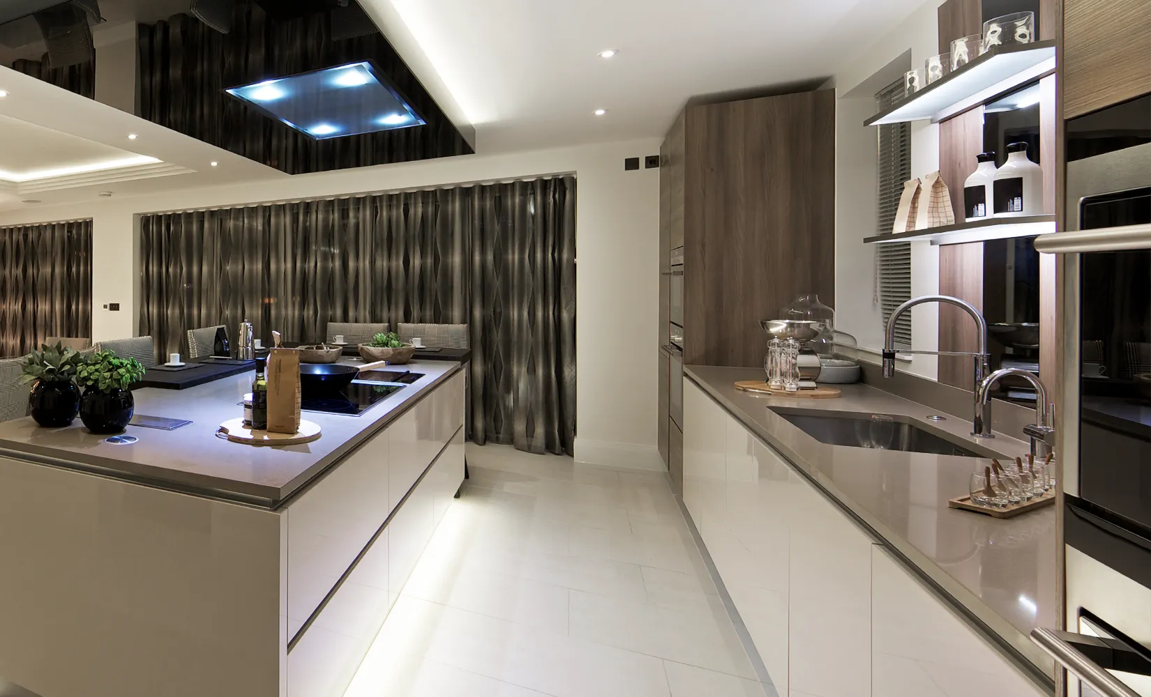 Galley kitchen with under cabinet lighting under kitchen island.