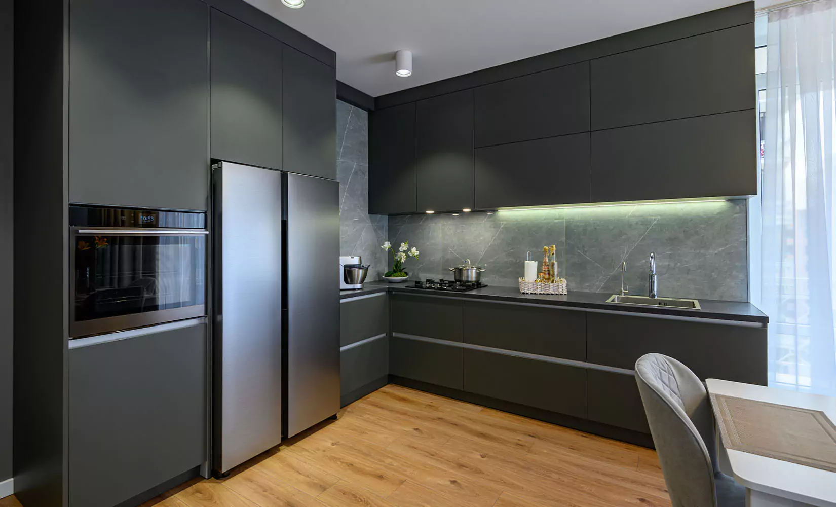 Modern kitchen with dark gray slab cabinets.
