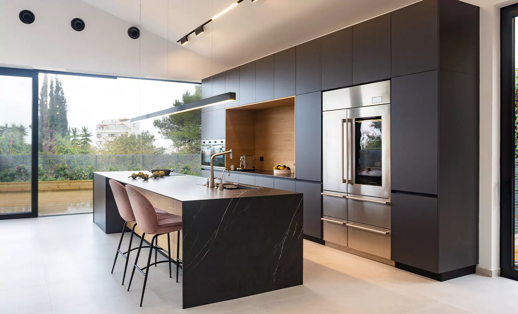 Modern kitchen with charcoal colored slab cabinets.