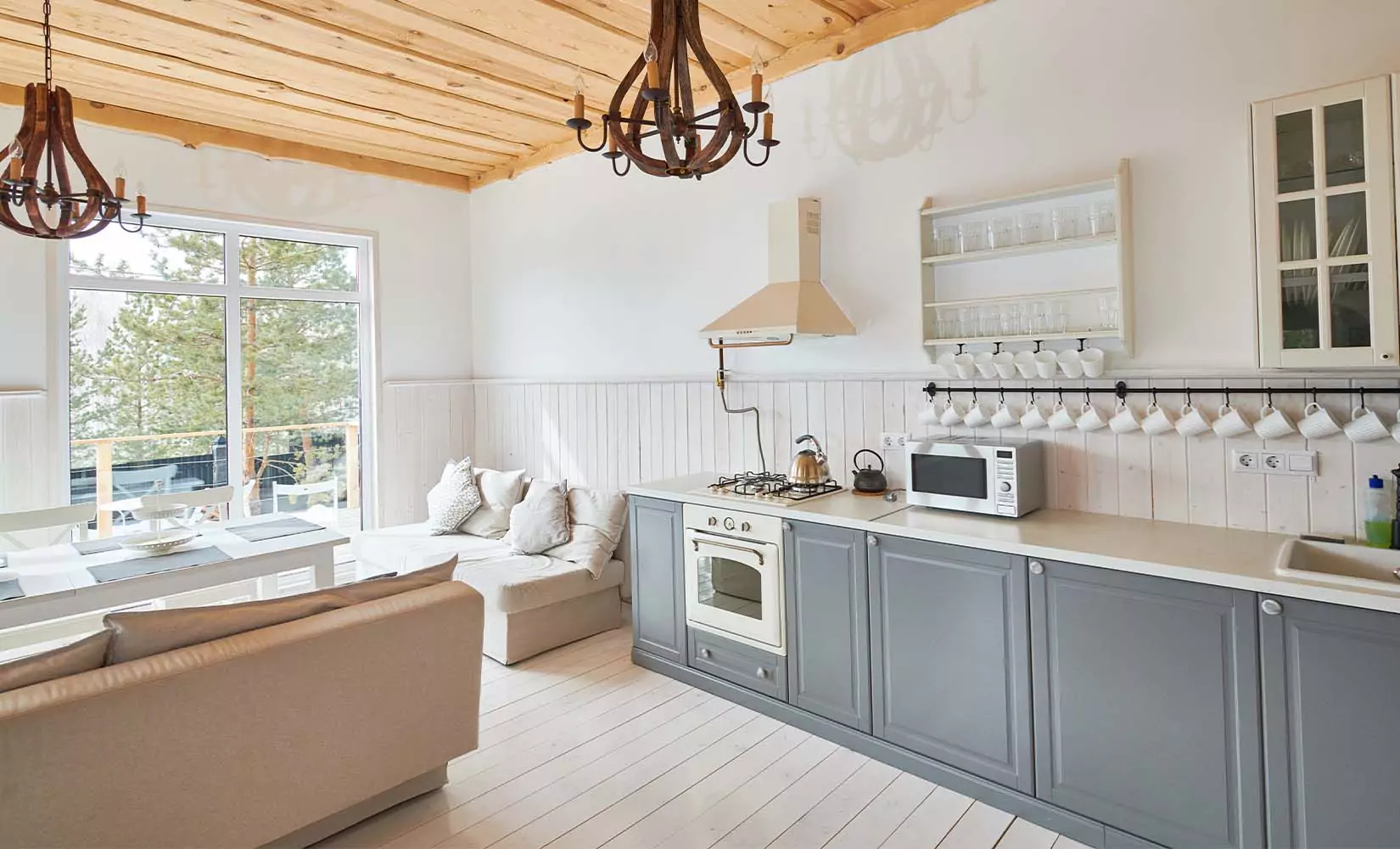 Gray farmhouse kitchen with reclaimed wood ceiling.