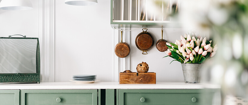 Luxury kitchen with green kitchen cabinets.