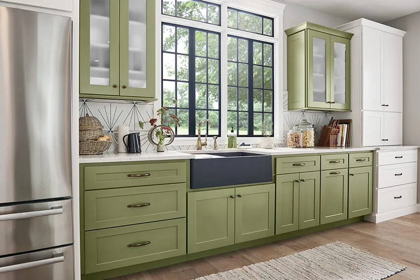 Modern farmhouse kitchen with green kitchen cabinets.