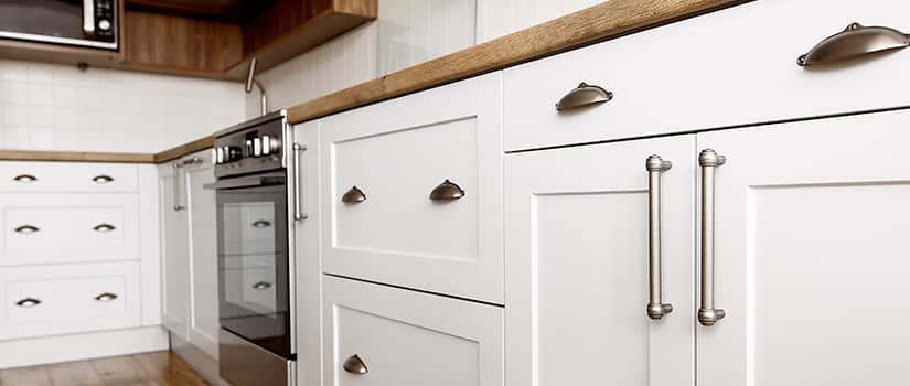 Kitchen cabinet hardware in a modern-rustic white kitchen.