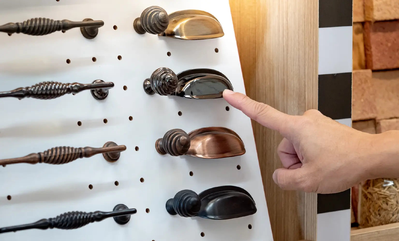 Display of cabinet pulls, knobs, and handles in different finishes.