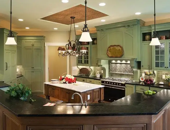 Eclectic kitchen with repainted green cabinets.