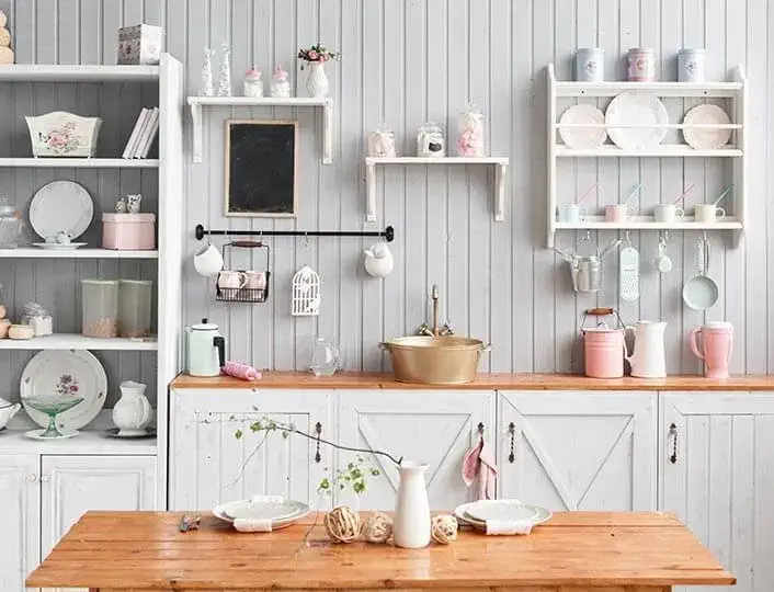 Shabby chic rustic kitchen with painted white cabinets.