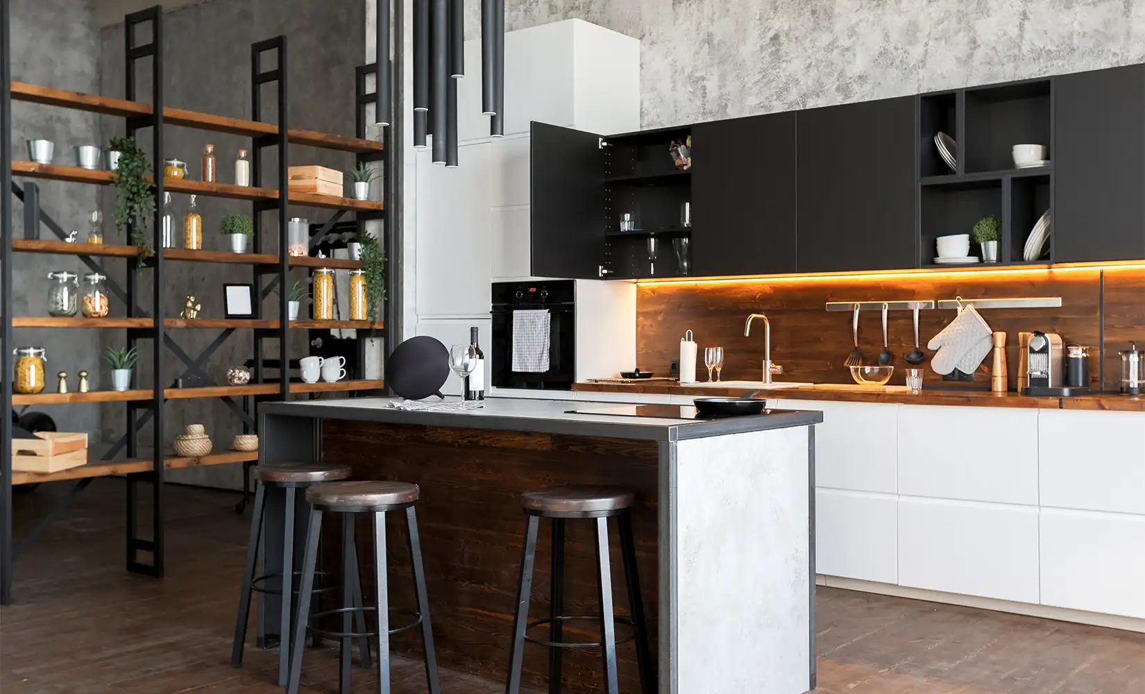 Classic industrial kitchen with island, white and black cabinet accents, multi-tier wooden shelves, and appliances on wooden countertops.