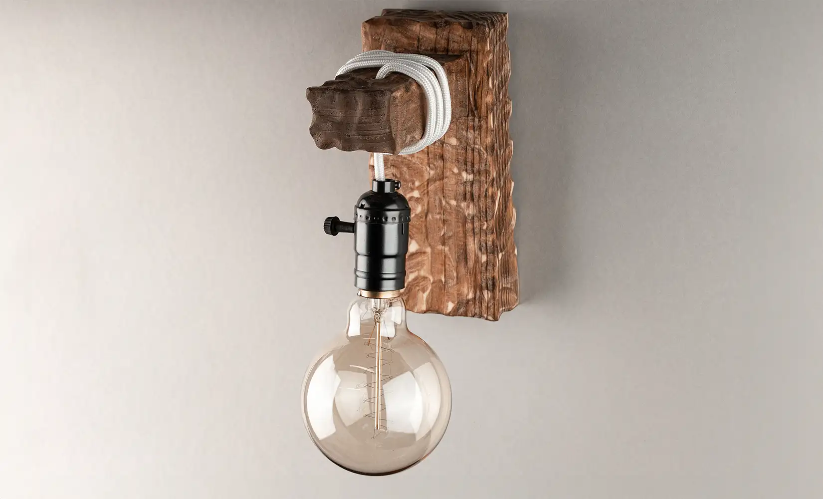 Wooden wall sconce lighting decor with Edison bulb attached.