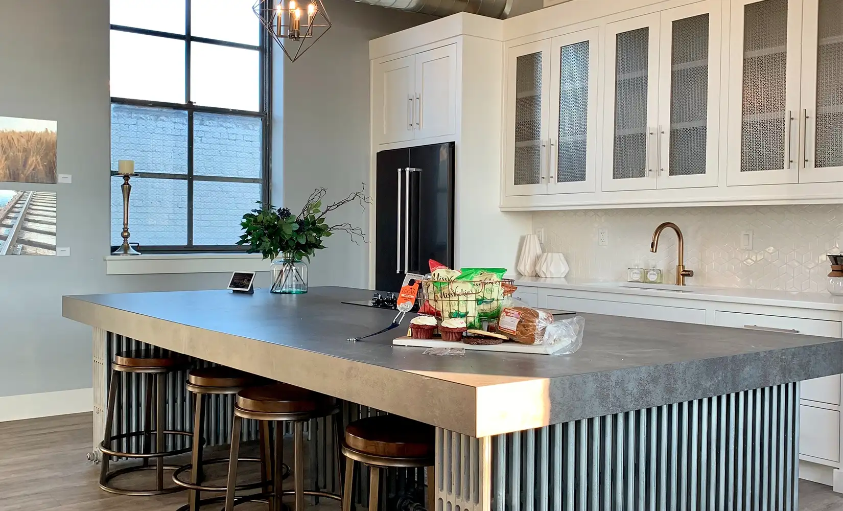 Industrial kitchen with wooden kitchen island decor and pendant light fixtures.