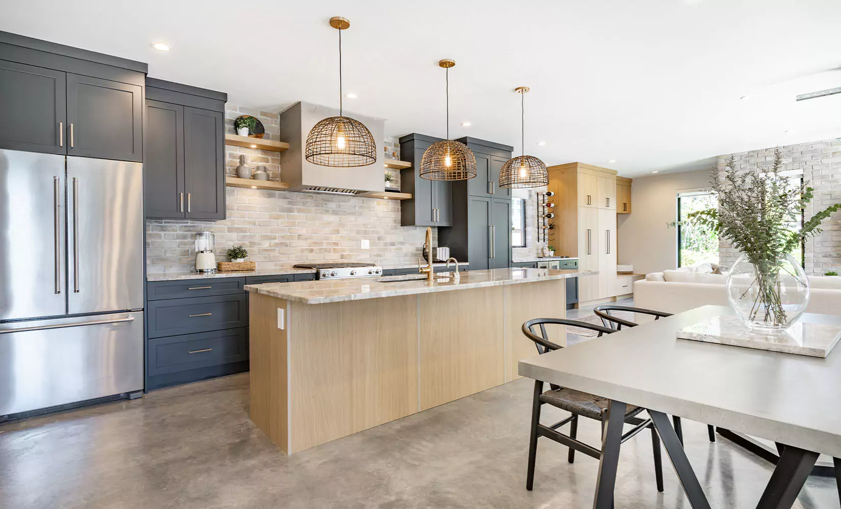 Kitchen with long central island separating kitchen from dining area.