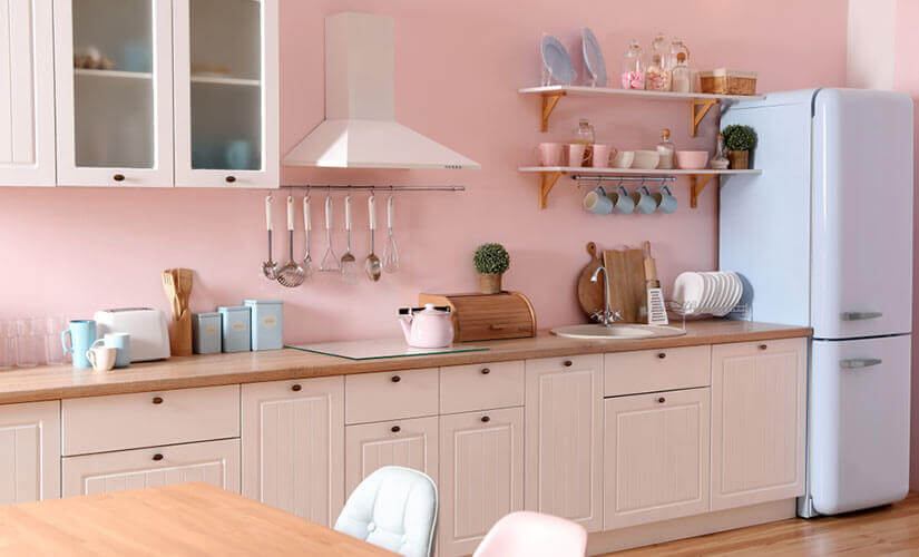 pastel pink kitchen accent wall with pale blue fridge