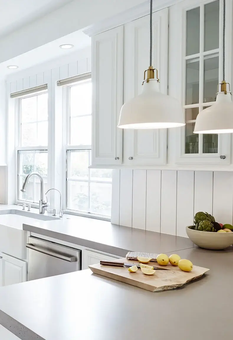 Open kitchen with island, granite countertops, and white Shiplap wood kitchen backsplash and walls.