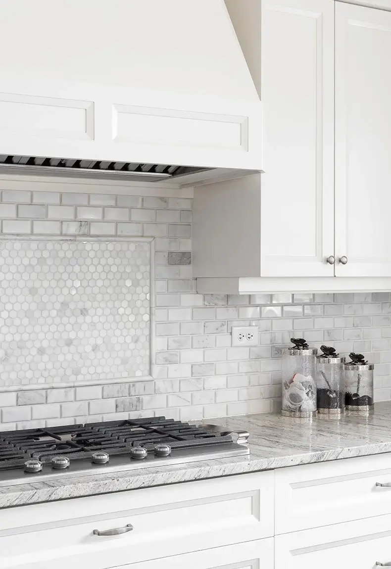 Off white and gray kitchen aesthetic with matching gray cabinets, and gray and matching white and gray tile backsplash.