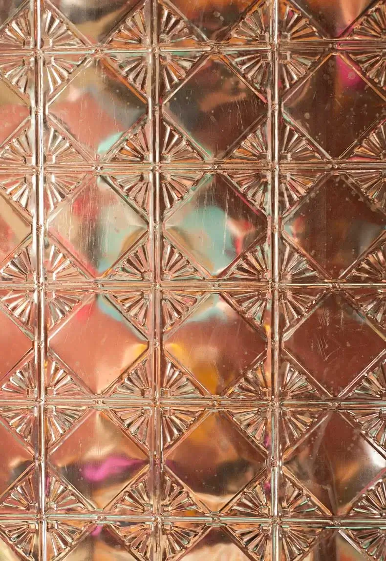 Shiny copper pressed tin material for kitchen backsplash decor.