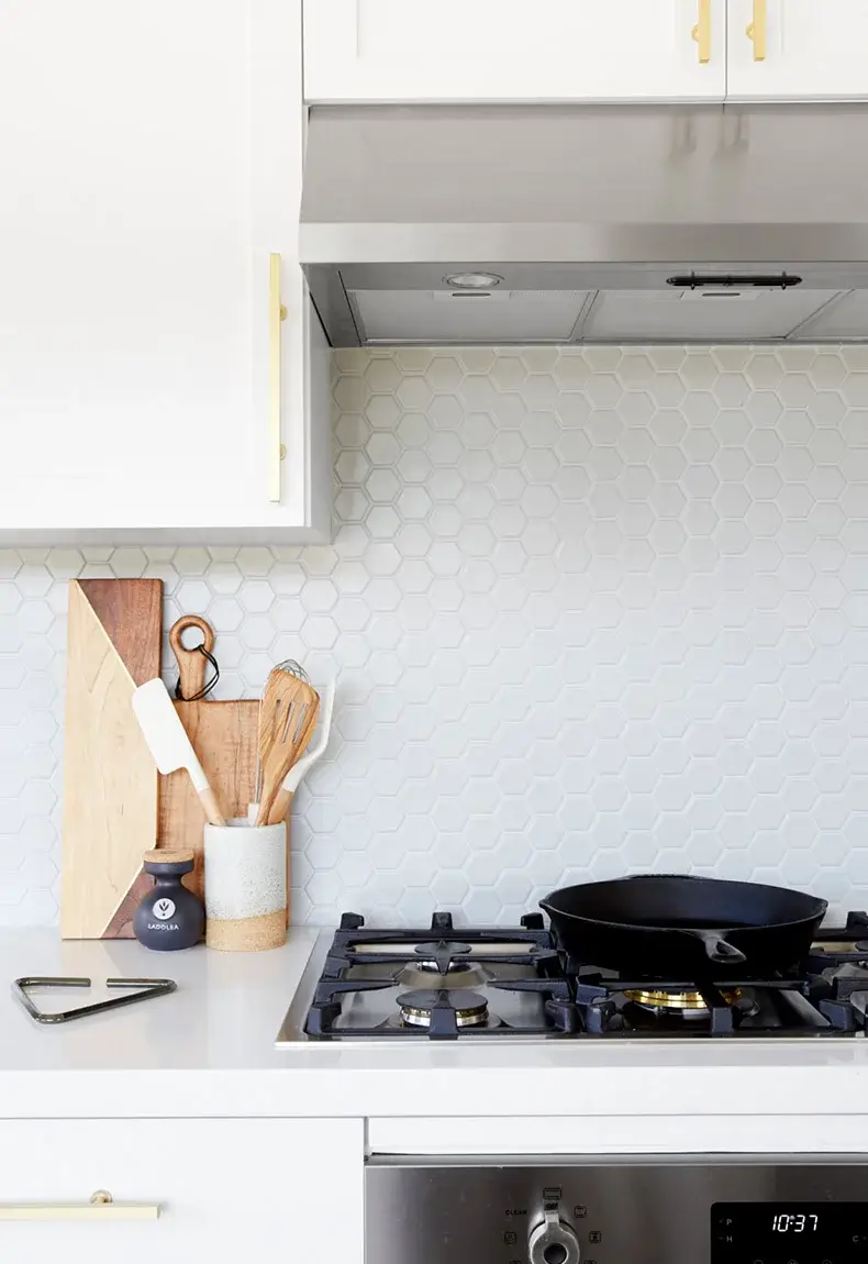 White tile hexagon-shaped kitchen kitchen backsplash.