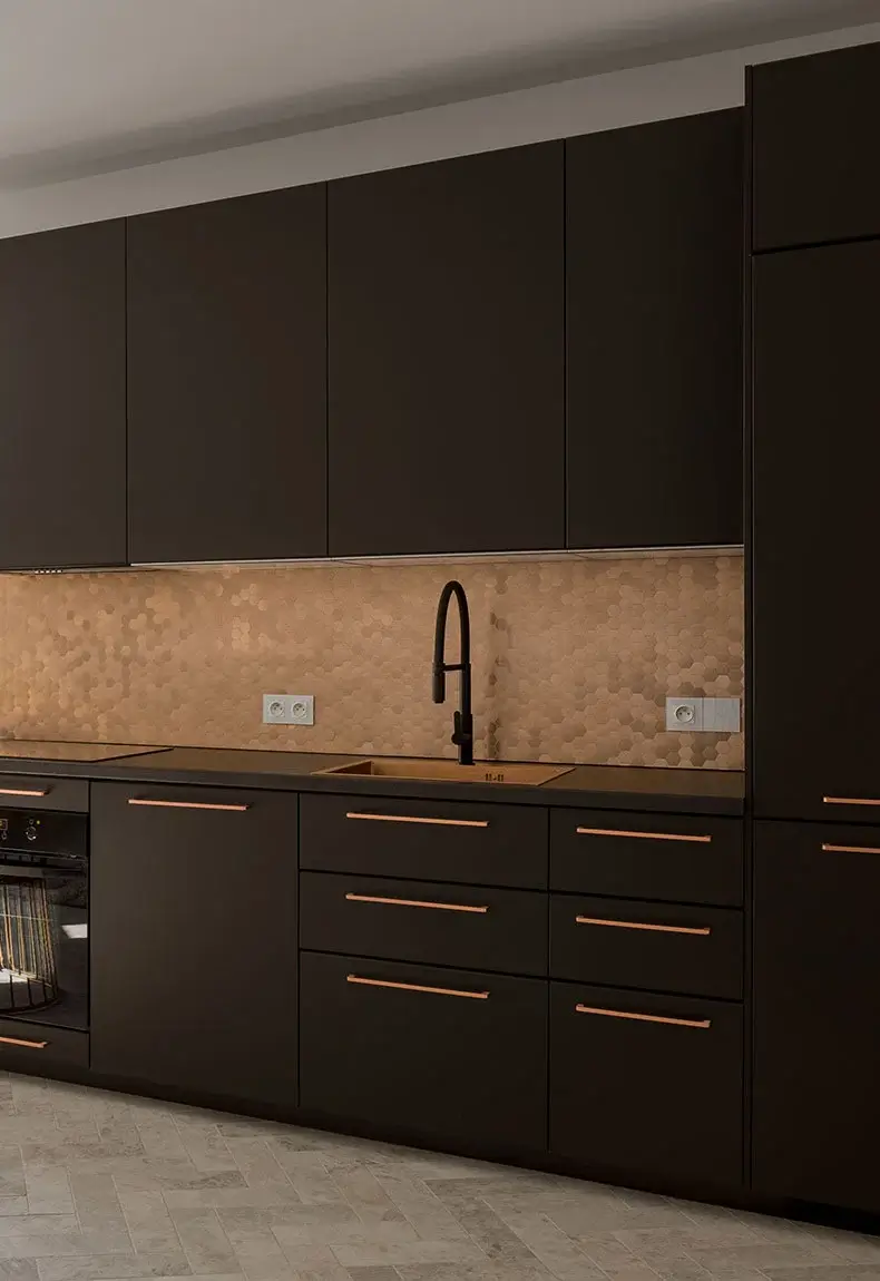 Kitchen with dark brown cabinets and copper-accented handles, and a penny backsplash.