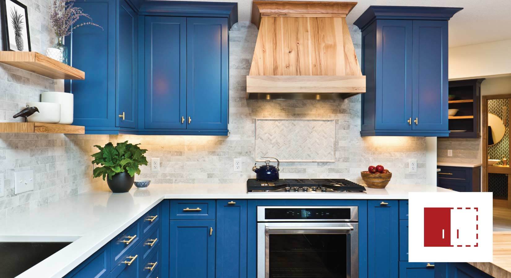 Bright blue semi-custom kitchen cabinets with gold hardware.