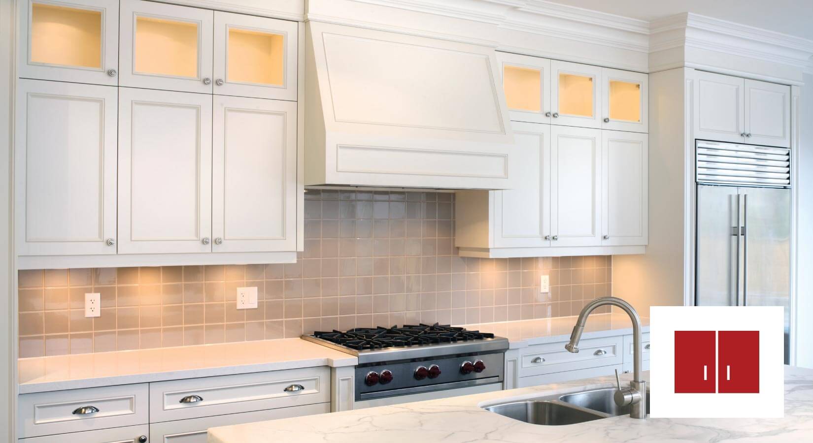 Simple white stock kitchen cabinets with brown tile backsplash.