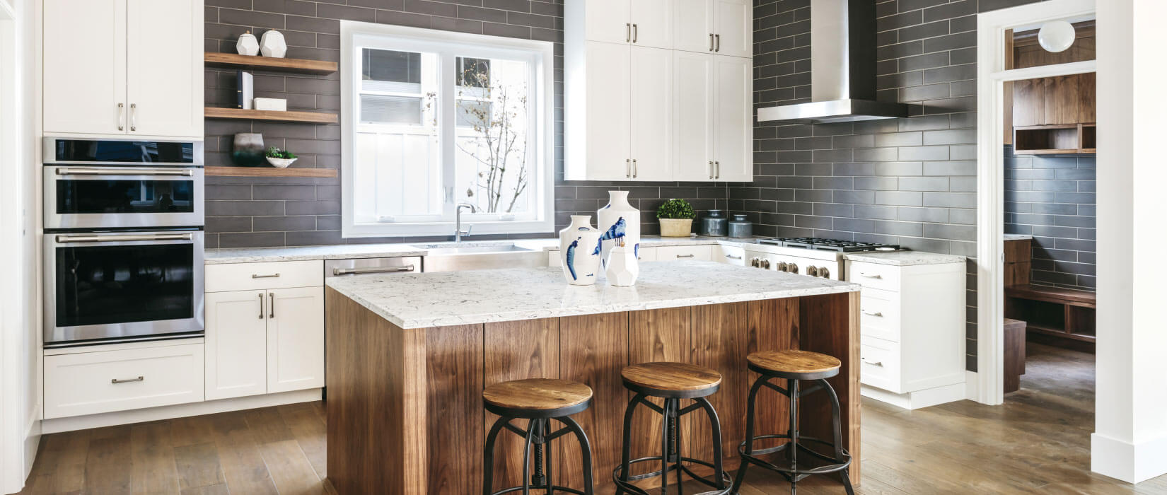 Contemporary kitchen with white shaker style cabinets and center island.