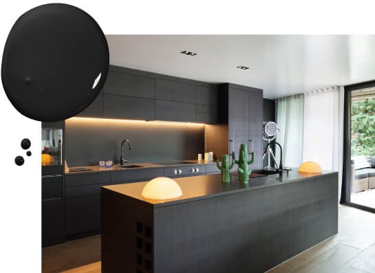 Kitchen with black flat cabinets, black appliances and built-in dome lights on kitchen island.
