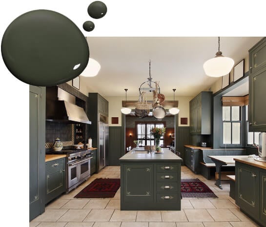 Large kitchen with forest green painted cabinets, kitchen island and dining nook.