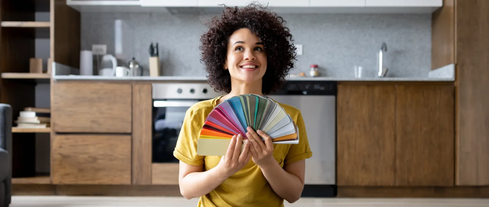 Smiling woman holding paint color samples.