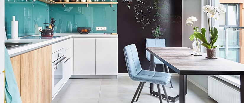 Ceramic floors with bamboo cabinets, white appliances, and turquoise backsplash.