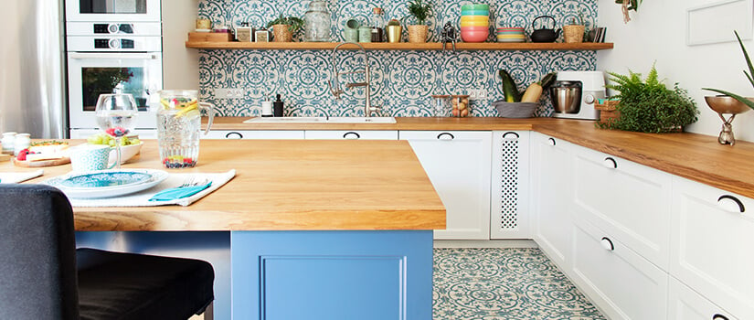 Eclectic style kitchen with blue patterned floor and backsplash.