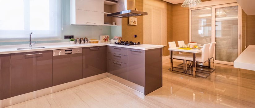 Quartzite tile floors in sleek, modern kitchen with brown slab cabinets.
